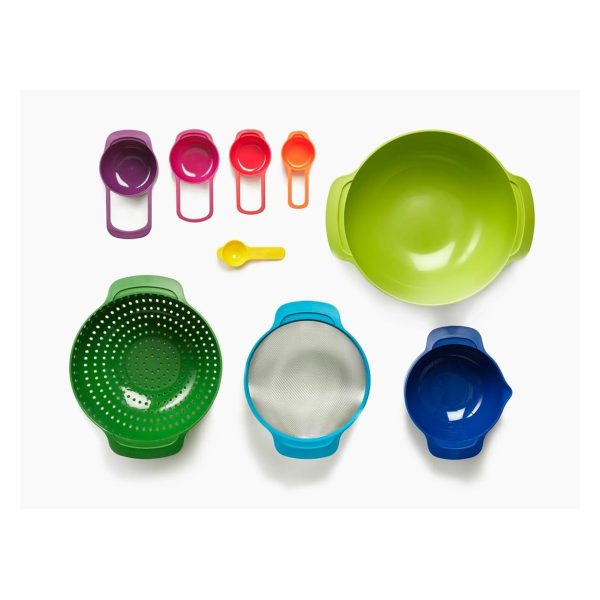 The nine pieces of the Joseph Joseph Nest 9 set laid out separately: five colour-coded measuring cups, a colander, a sieve and two mixing bowls.