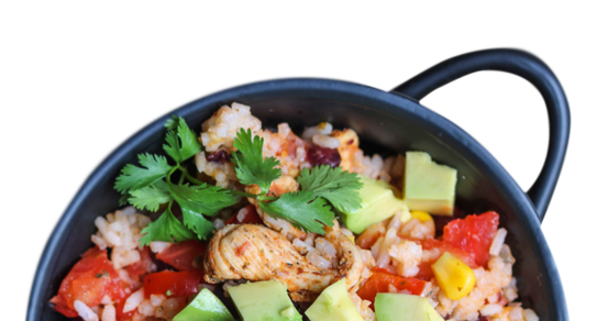 Bowl of rice topped with diced tomato, avocado and fresh parsley.