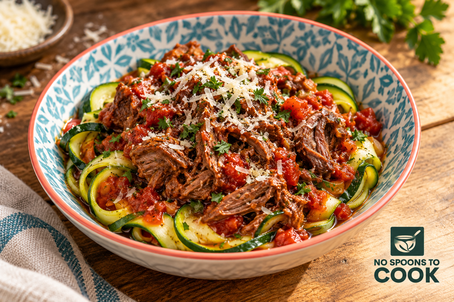 Shredded lamb ragu over zucchini ribbons, topped with grated cheese and parsley.