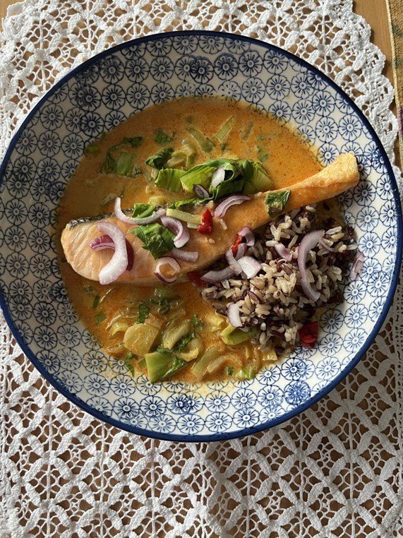 Bowl of quick Thai red salmon curry.